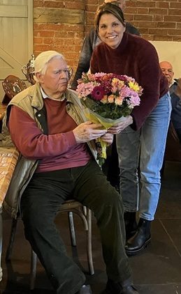 Georgina Crofts presentating Jim Summers with a bunch of flowers. 12 02 25A
